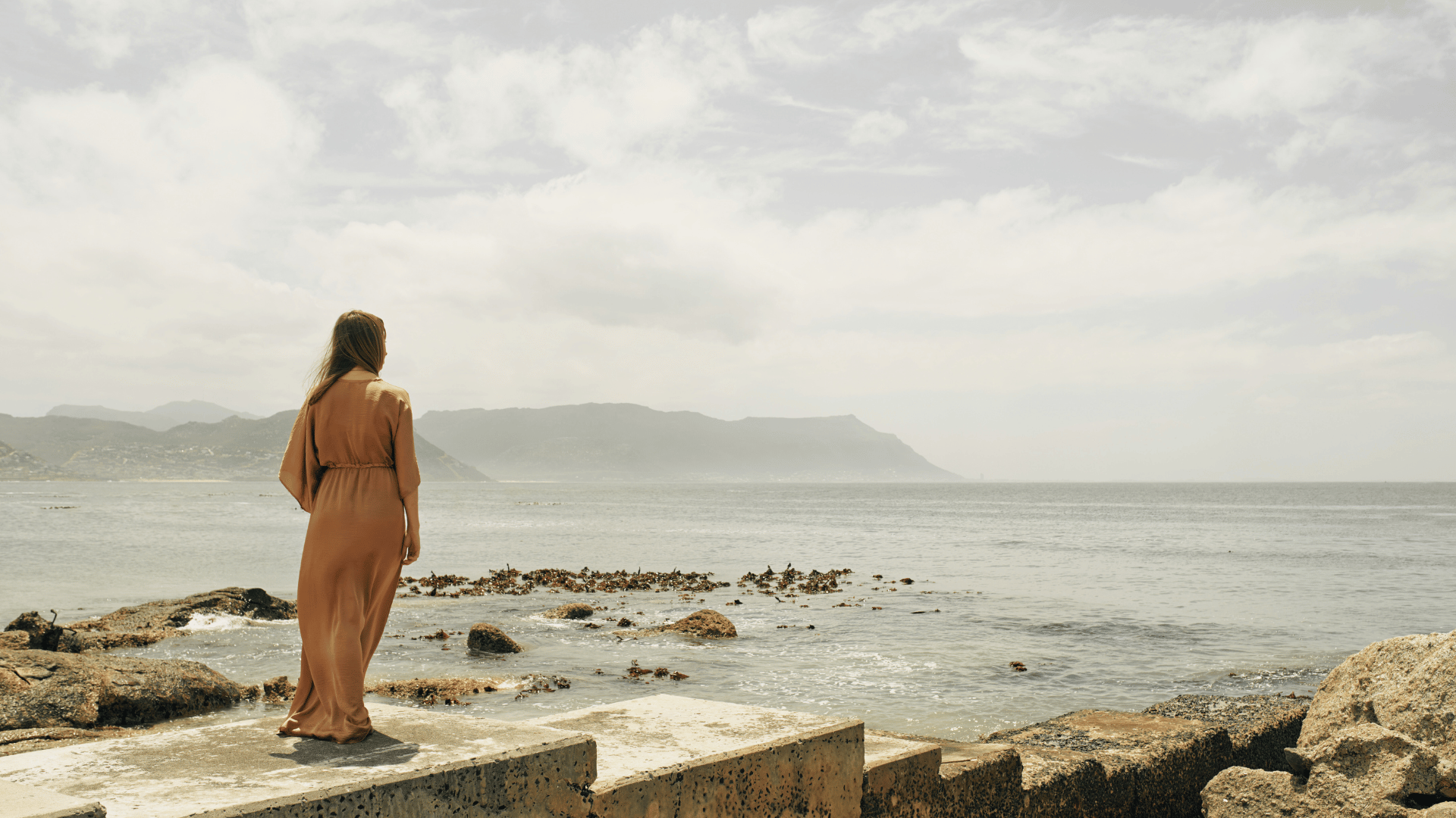 SWC Who is this for woman in dress staring longingly at the sea